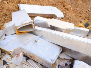 Valencia, Spain - August 6, 2019: Debris from damaged thermal insulators thrown in the trash.
