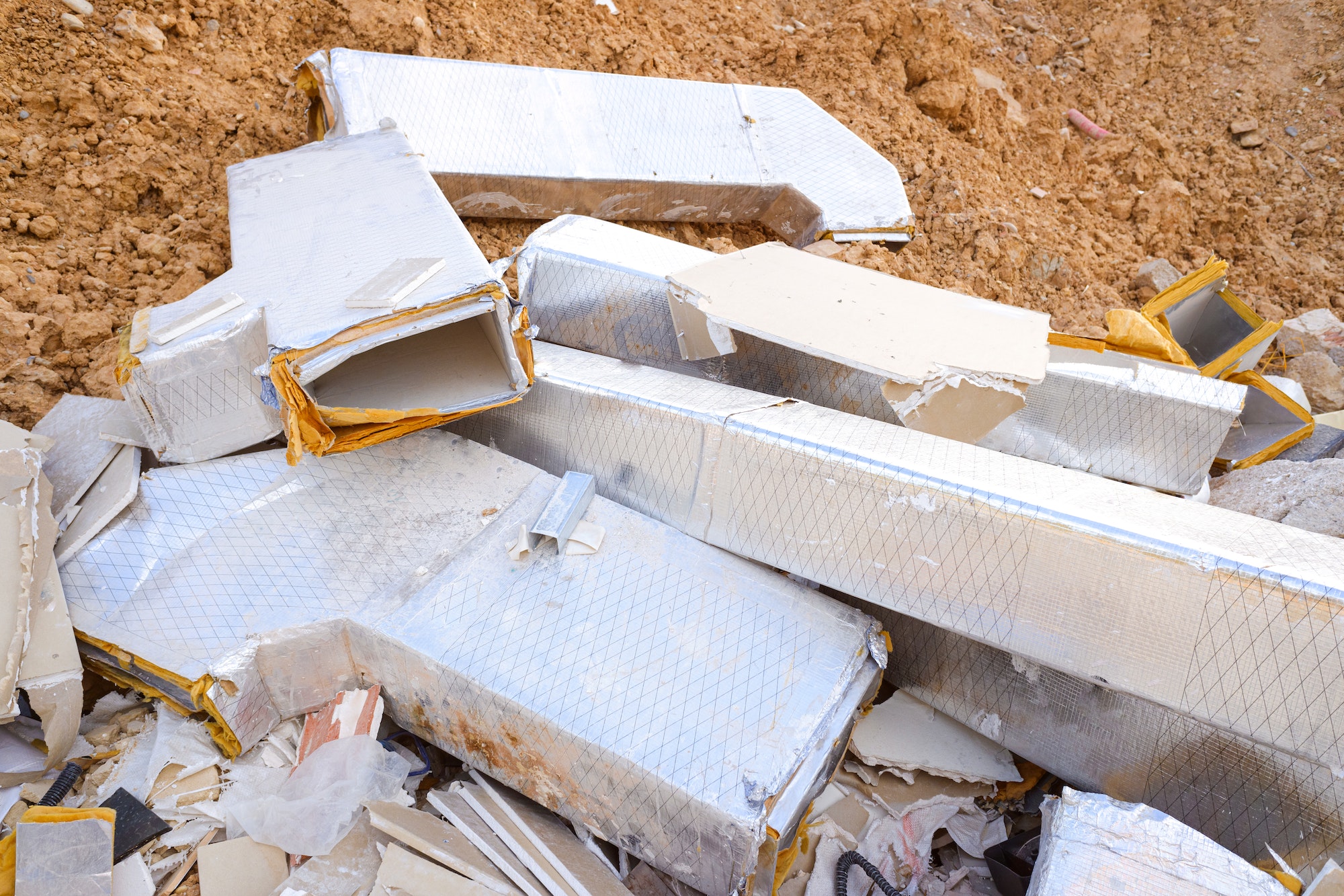 Valencia, Spain - August 6, 2019: Debris from damaged thermal insulators thrown in the trash.