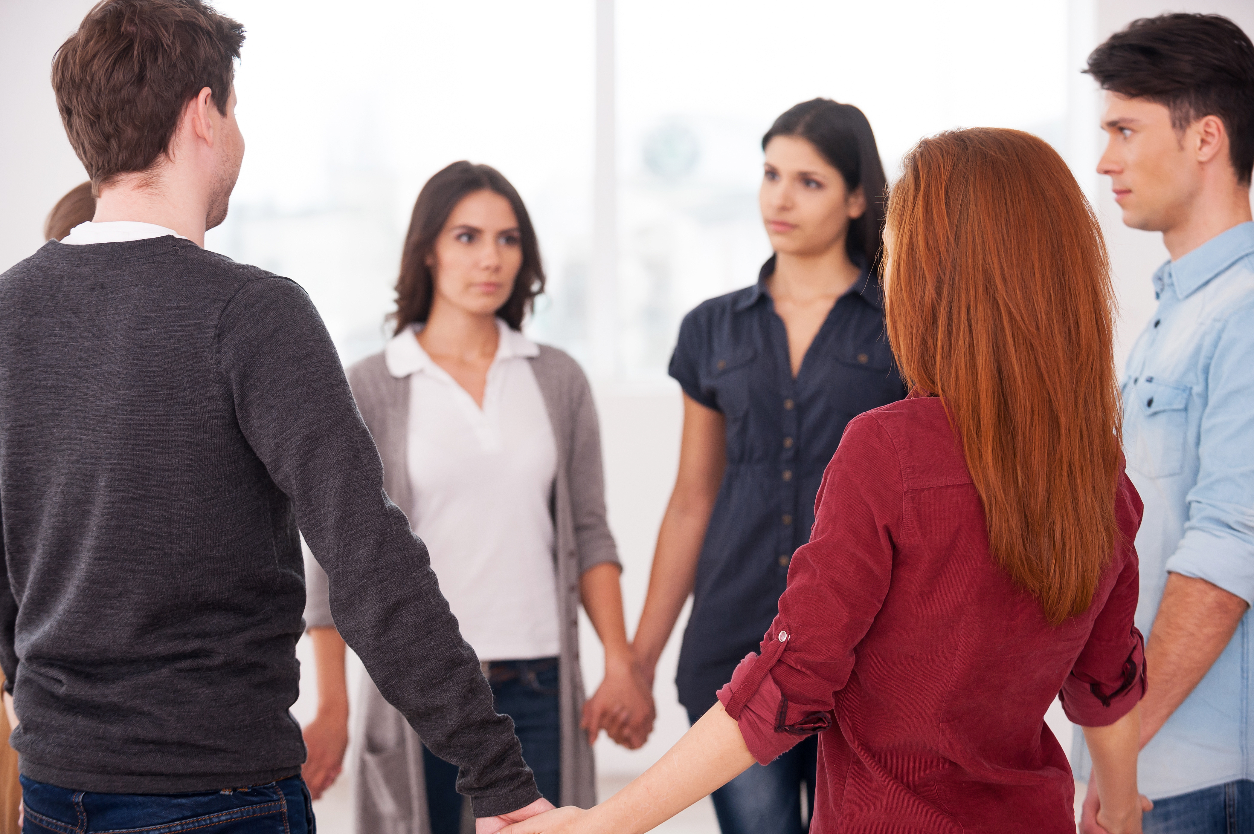 Trust circle. Group of people standing in circle and holding hands