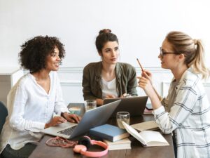 Group of cheerful young women studying together