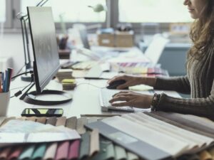 Designer working with her computer in her studio
