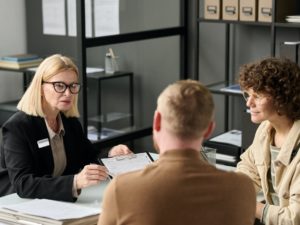 Female insurance broker consulting couple