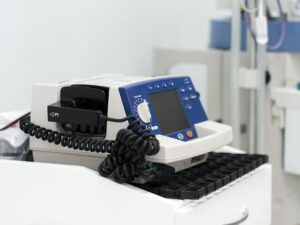 There is a defibrillator on the table in the white ward. The concept of saving people's lives.