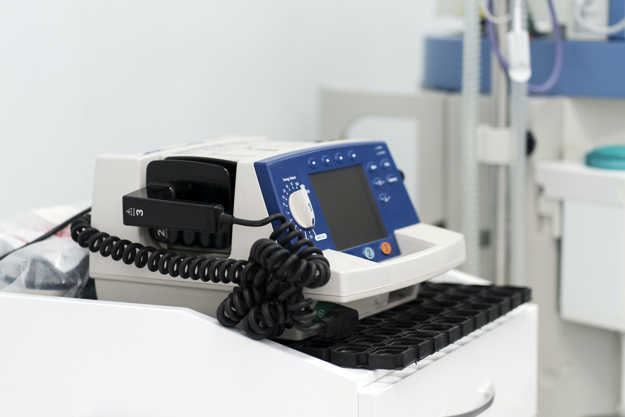 There is a defibrillator on the table in the white ward. The concept of saving people's lives.