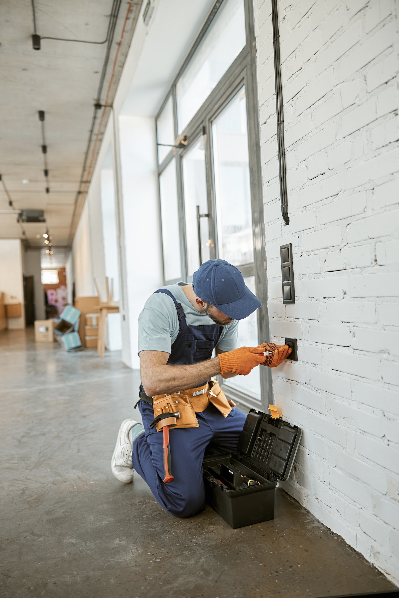 Electrician fixing power electric socket with screwdriver