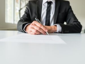 Business employer signing paperwork