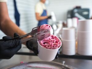 Stir-fried ice cream rolls at freeze pan. Rolled ice cream, hand made ice cream dessert.