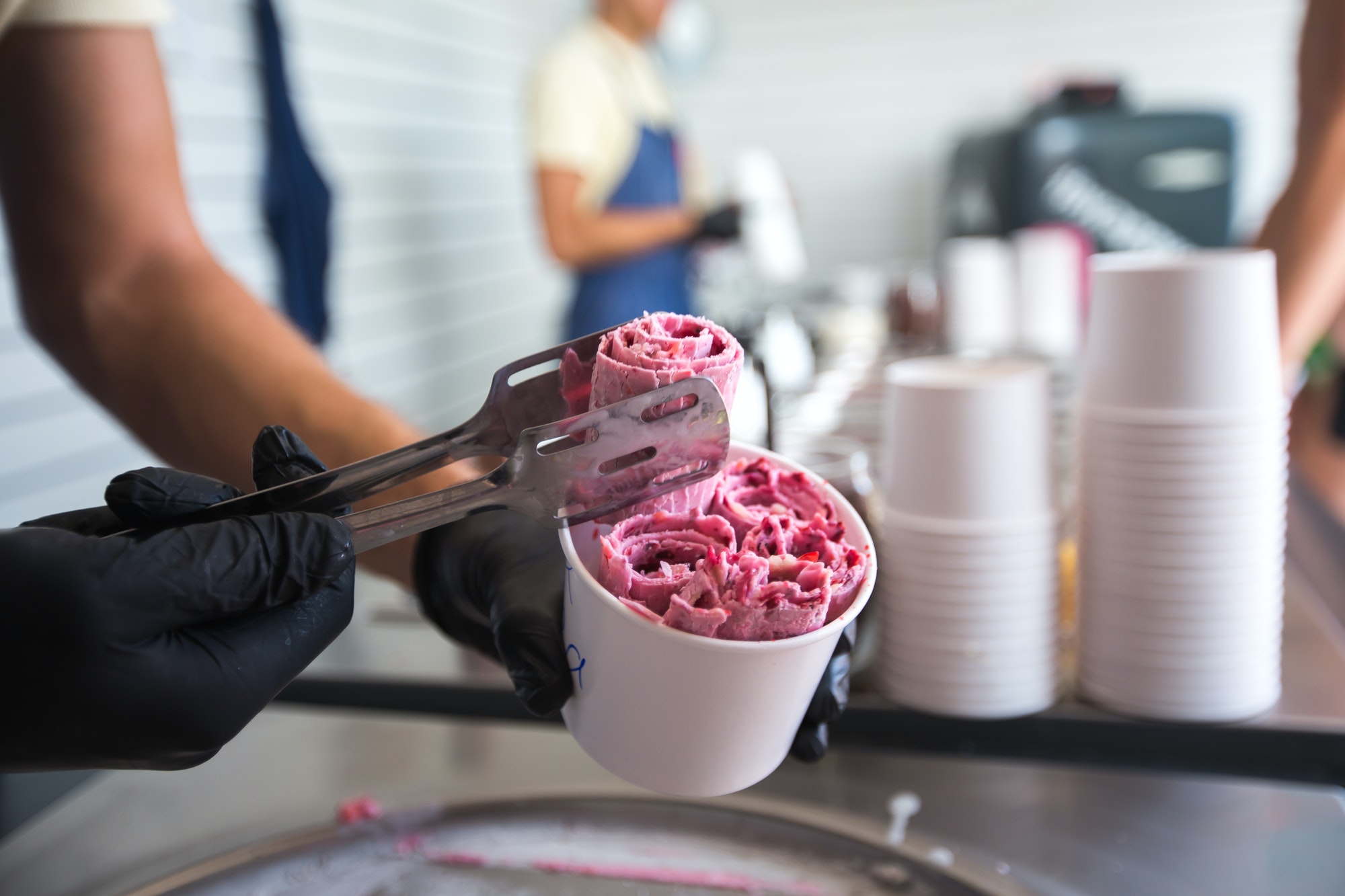 Stir-fried ice cream rolls at freeze pan. Rolled ice cream, hand made ice cream dessert.